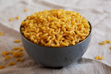 Bowl of Dry Organic Macaroni Elbow Pasta, Ready to be Cooked. Close-up.
