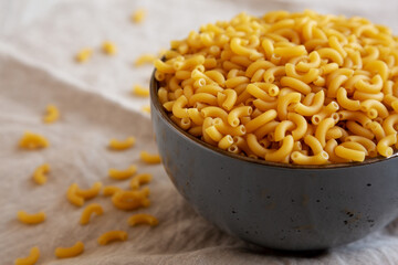 Bowl of Dry Organic Macaroni Elbow Pasta, Ready to be Cooked. Copy space.