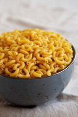 Bowl of Dry Organic Macaroni Elbow Pasta, Ready to be Cooked. Close-up.