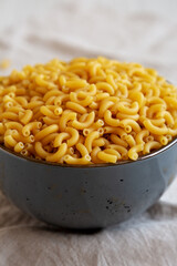 Bowl of Dry Organic Macaroni Elbow Pasta, Ready to be Cooked. Close-up.