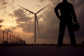 Engineer man working at windmill farm generating electricity clean energy. Wind turbine farm...