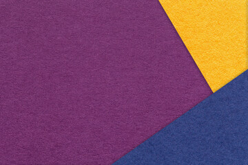 Fototapeta premium Texture of craft violet color paper background with yellow and blue border. Vintage abstract purple cardboard.