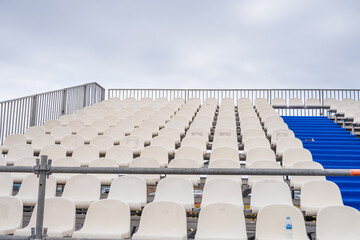 Obraz premium detail of the blue and white plastic seats of the bleachers installed in an esplanade of a public parking lot for an open air concert. Puerto de la Cruz, Tenerife, Canary Islands, Spain