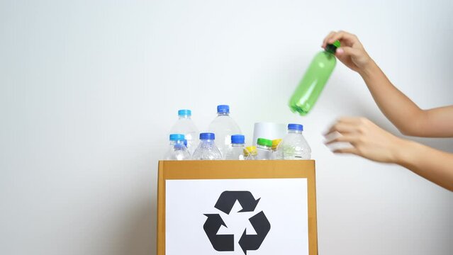 Volunteer keep plastic bottle into paper box at home or office. Hand Sorting Recycle garbage. Ecology, Environmental, pollution, Dispose recycling, waste management and trash Separation concept