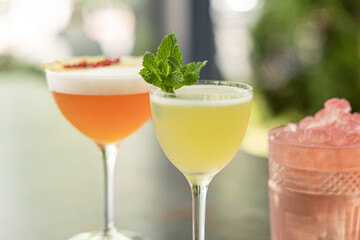 Different delicious summer cocktails on grey table in bar