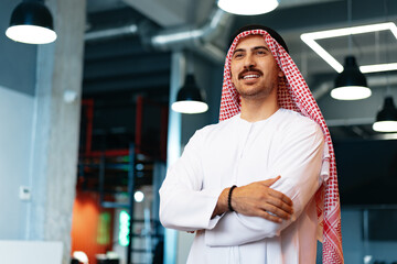 Successful muslim businessmen in traditional outfit in his office
