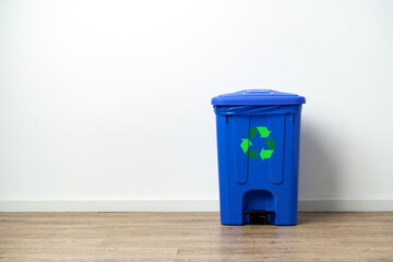Plastic waste bin with lid in the room