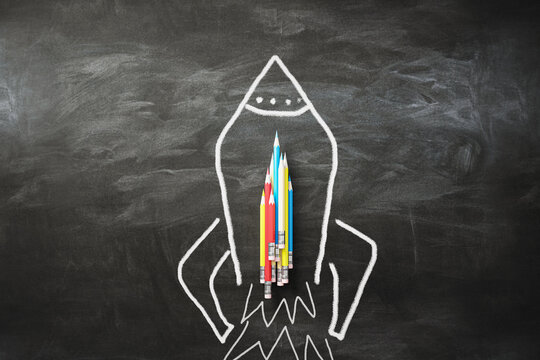 Startup and business idea concept with colorful pencils on the rocket drawn on blackboard background. 3D rendering
