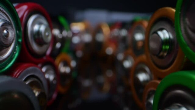 Close-up of old alkaline batteries, commonly used in toys and small appliances. Shot in macro against a dark background.
