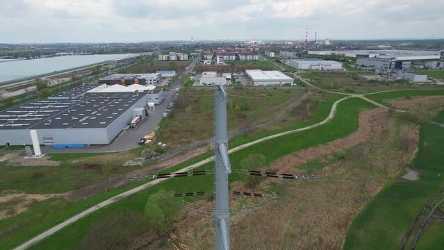 Industrial area with power line and ceramic insulators viewed from drone camera.