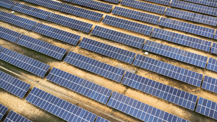 Obraz premium Top view on photovoltaic solar power panels. Drone aerial view of Solar panels system power generators from sun. Alternative Energy Sources - The Concept of Sustainable Resources.
