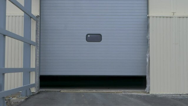 Roller security shutter in large heavy industry plant. Coiling door or sectional overhead door