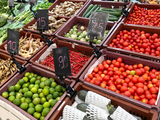 Various kinds of fresh vegetable in the basket at the supermarket with the price