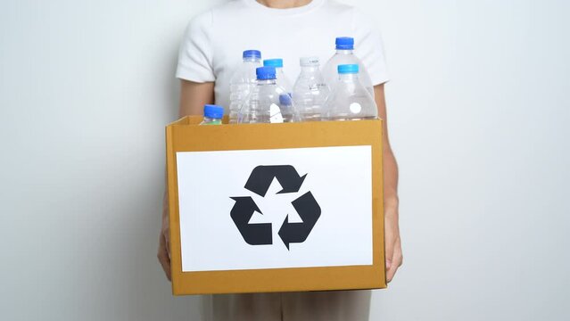 Volunteer keep plastic bottle into paper box at home or office. Hand Sorting Recycle garbage. Ecology, Environmental, pollution, Dispose recycling, waste management and trash Separation concept