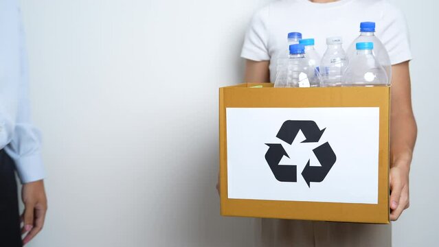 Volunteer keep plastic bottle into paper box at home or office. Hand Sorting Recycle garbage. Ecology, Environmental, pollution, Dispose recycling, waste management and trash Separation concept