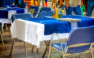 Tables with cutlery in a cafe on barcelona street. Photos from the trip