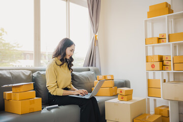 Freelance Female SME Small Business Entrepreneur Working at Office BOX, Tablet and Laptop Online, Marketing, Packaging, Shipping, Ecommerce Concept..