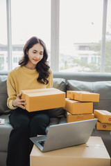 Small Business Entrepreneur SME Female Freelance Work From Home Happy young woman working BOX, tablet and laptop online, marketing, packaging, shipping, e-commerce concept..
