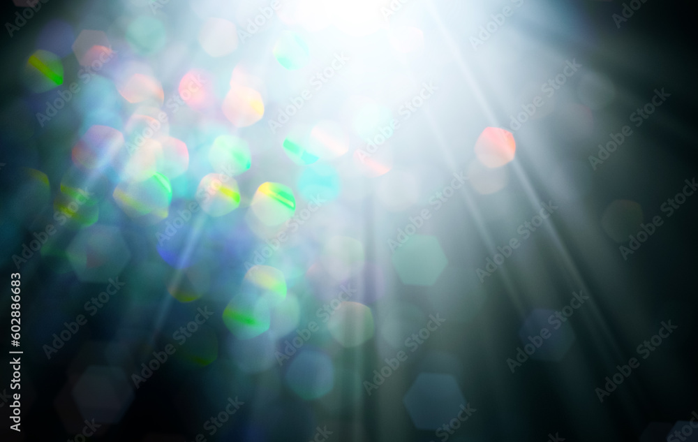 Wall mural rays of light with colorful bokeh on black background. abstract background.