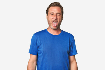 Fototapeta premium A middle-aged man isolated funny and friendly sticking out tongue.