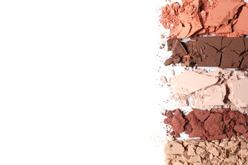 Swatches of crushed eye shadows on white background, top view. Space for text