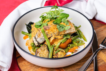 Grilled Barramundi with roast vegetables and creamy sauce