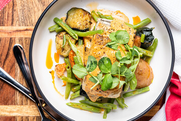 Grilled Barramundi with roast vegetables and creamy sauce