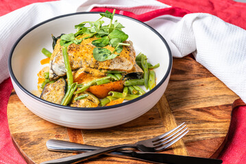 Grilled Barramundi with roast vegetables and creamy sauce
