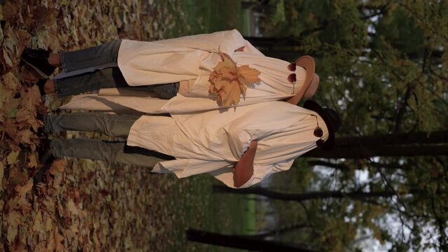 Ghost costume for Halloween party. Two ghosts walking in autumn forest. Halloween concept.