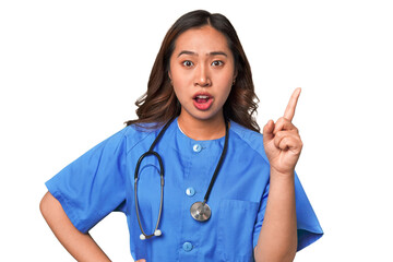 A young nurse chinese woman having an idea, inspiration concept.