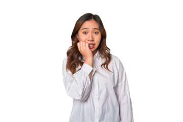 A young chinese woman biting fingernails, nervous and very anxious.