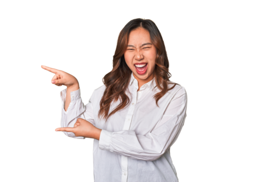 A young chinese woman pointing with forefingers to a copy space, expressing excitement and desire.