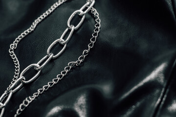 Chain on black texture eco soft leather, fashionable jacket.