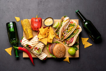 Obraz na płótnie Canvas Mexican food featuring tacos, burritos, nachos, burgers