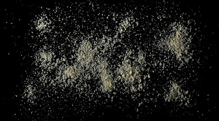 Obraz premium Almonds ground pile scattered isolated on black, top view, clipping path 