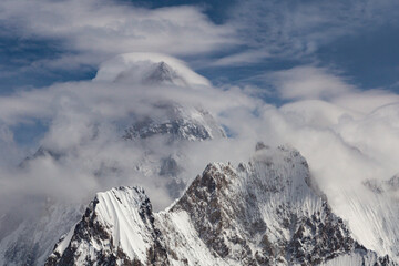 Fototapeta na wymiar beautiful view og g 4 or gesherbrum 4 under the cluds in blue sky, Gasherbrum IV, surveyed as K3, is the 17th highest mountain on Earth and the 6th highest in Pakistan