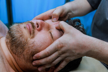 Manual therapist focuses on anti-aging face massages to stimulate blood circulation enhance the...