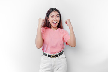 Obraz na płótnie Canvas A young Asian woman with a happy successful expression wearing pink t-shirt isolated by white background