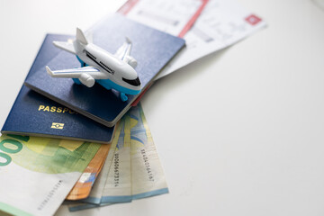 Air tickets, passports, money and toy plane on table - obrazy, fototapety, plakaty