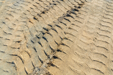 Impints of the truck tires on sand near quarry. Earthworks, offroad