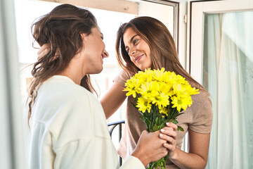 Enamored duo, balcony-bound, share beautiful moment.