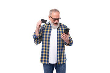 well-groomed 50s mid-aged gray-haired retired man with mustache and beard pays for online purchases