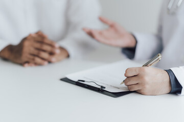 dentist and patient discussion about planned teeth treatment in dental clinic office room.