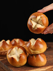 Laugenbrezel(Brezen),Lye bread in the shape of a peach with a cross cut in the middle, on a dark background