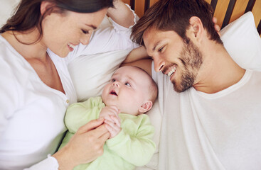 Top view of happy family, parents and baby in bedroom for love, care and quality time together at home. Mother, father and newborn kid relax on bed with support, childhood development and happiness