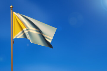 Tuva. Flag blown by the wind with blue sky in the background.