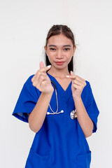 Portrait of a young and bubbly medical student, nurse, intern doing the finger heart sign on both...
