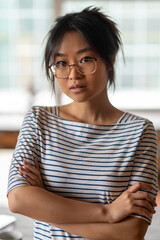 Young asian woman in striped shirt at home