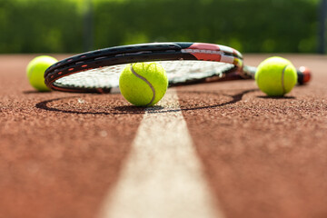 tennis racket with a tennis ball on a tennis court