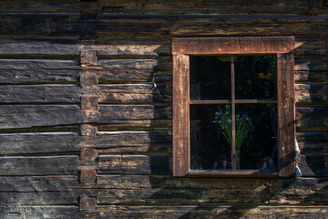 Fototapeta na wymiar Ancient wooden window with flower